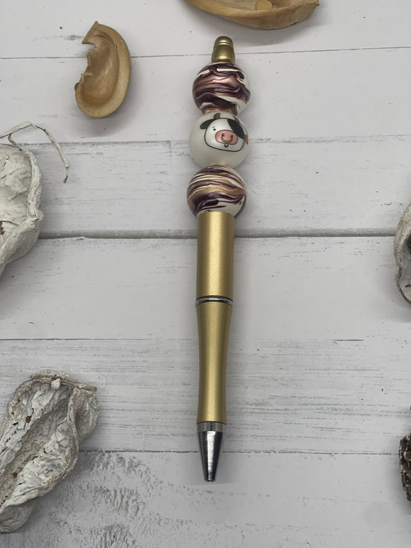 Beaded brown and gold with cow face pen