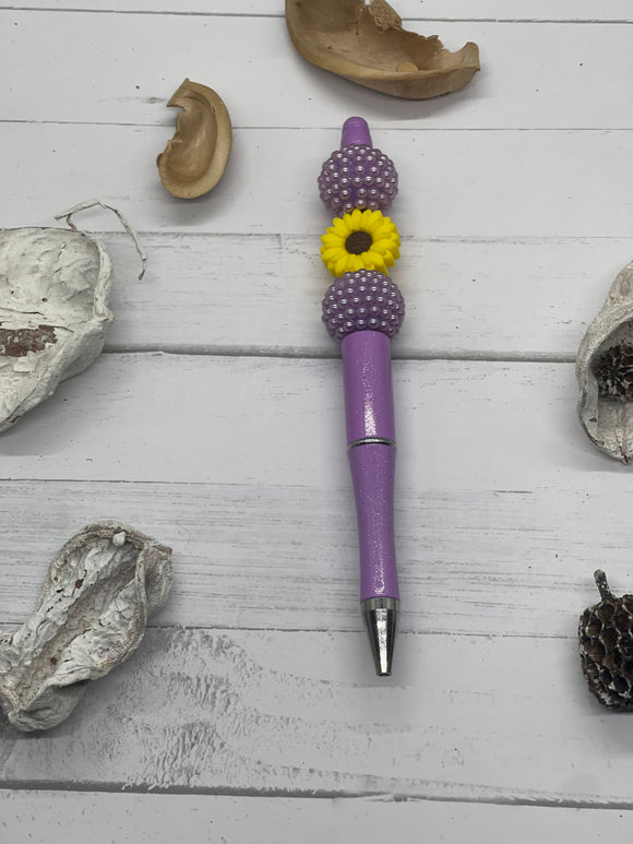 Purple beaded pen with yellow flower